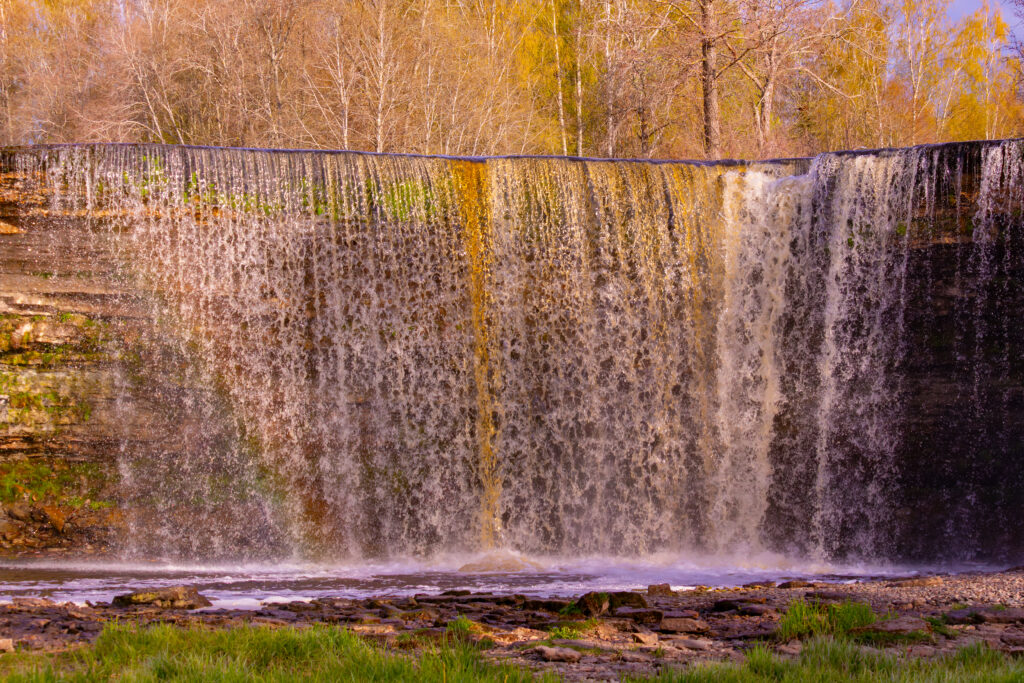 Jägala Waterfall in Estonia, captured in full flow during the spring, with surrounding nature and rocks / Jägala juga Eestis, jäädvustatud täisvoos kevadel, ümbritseva looduse ja kividega