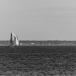 Black and white photo of a sailboat on the water / Mustvalge foto purjekast vee peal