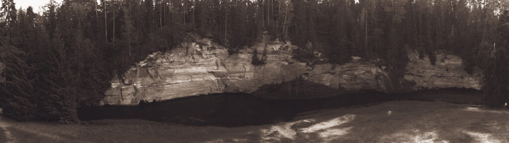 Sandstone cliffs of Suur and Väike Taevaskoda rising above the Ahja River in a lush Estonian forest