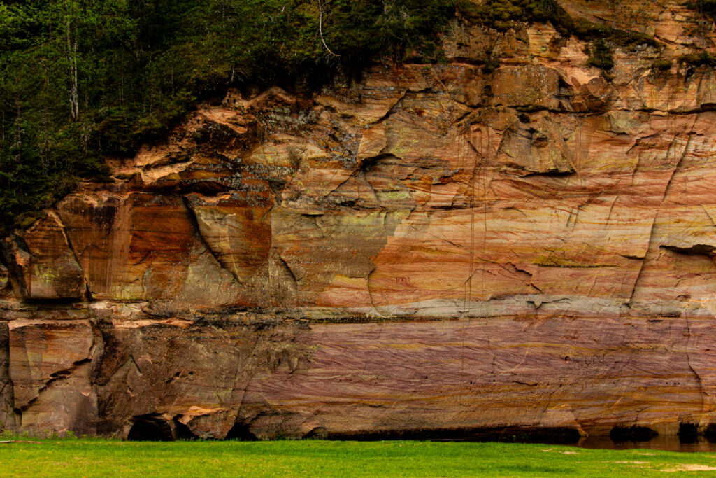 Sandstone cliffs of Suur and Väike Taevaskoda rising above the Ahja River in a lush Estonian forest