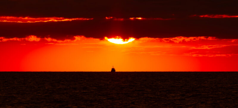 Fiery sunset over the Baltic Sea with a ship silhouette on the horizon, photographed from Paljassaare Peninsula, Estonia | Tulerõõmus päikeseloojang Läänemere kohal laeva siluetiga, pildistatud Paljassaare poolsaarelt, Eestist.