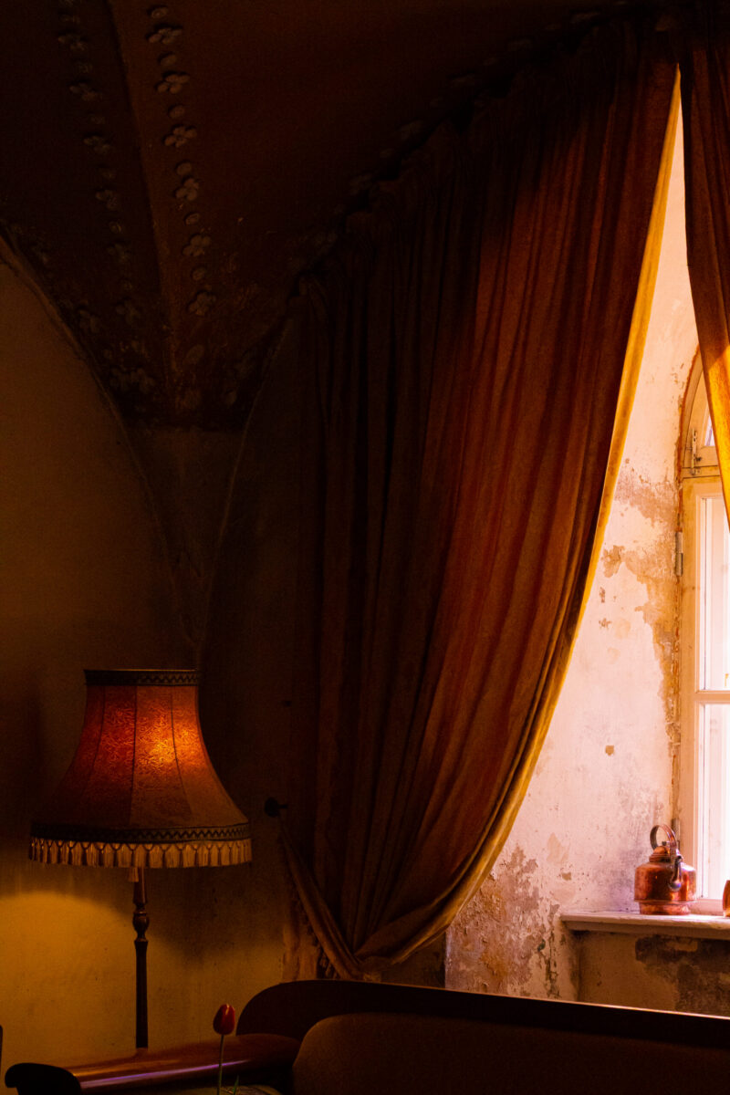 Rustic light filtering through a curtain in an old manor room / Rustikaalne valgus paistmas läbi kardina vanas mõisas