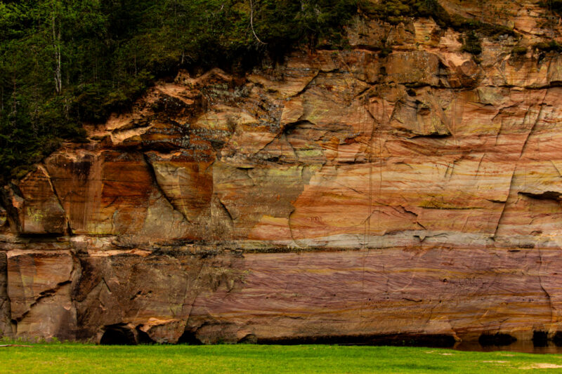 Sandstone cliffs of Suur and Väike Taevaskoda rising above the Ahja River in a lush Estonian forest
