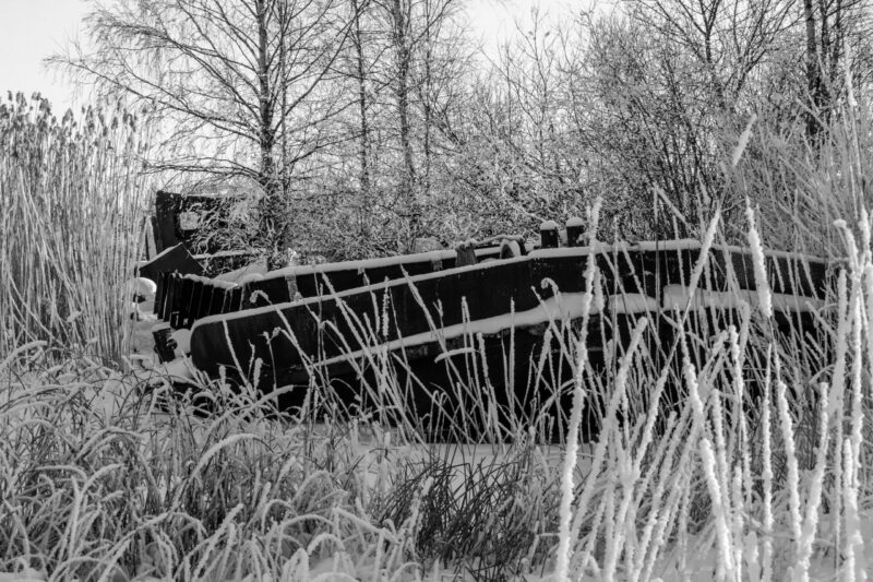 Abandoned boat in snowy landscape